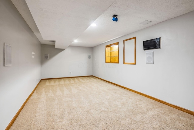 basement with carpet and a textured ceiling