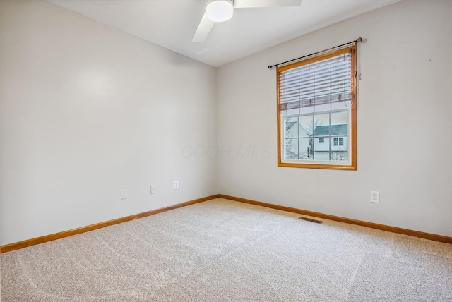 spare room featuring carpet flooring and ceiling fan