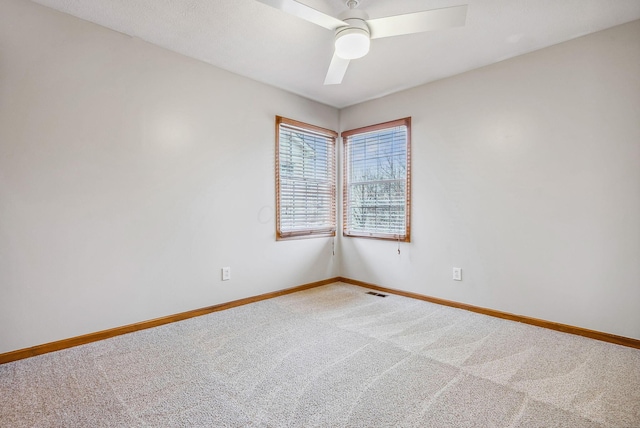 carpeted empty room featuring ceiling fan