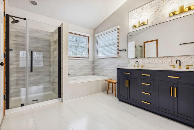 bathroom with tile patterned flooring, vanity, separate shower and tub, and vaulted ceiling