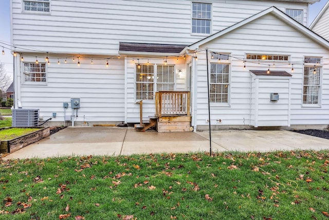 back of house featuring a yard, a patio, and central AC unit