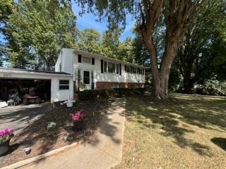 raised ranch featuring a front lawn