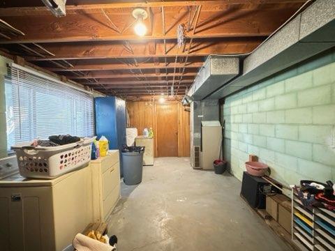 basement featuring washing machine and dryer and heating unit