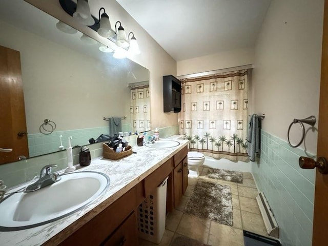 full bathroom featuring shower / bath combination with curtain, vanity, toilet, and tile walls