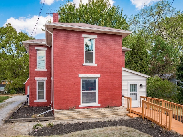 rear view of house with a wooden deck