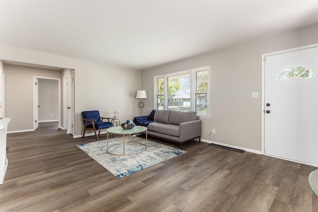 living room with dark hardwood / wood-style flooring