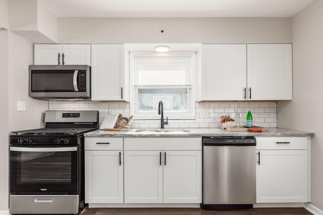 kitchen featuring white cabinets, backsplash, stainless steel appliances, and sink