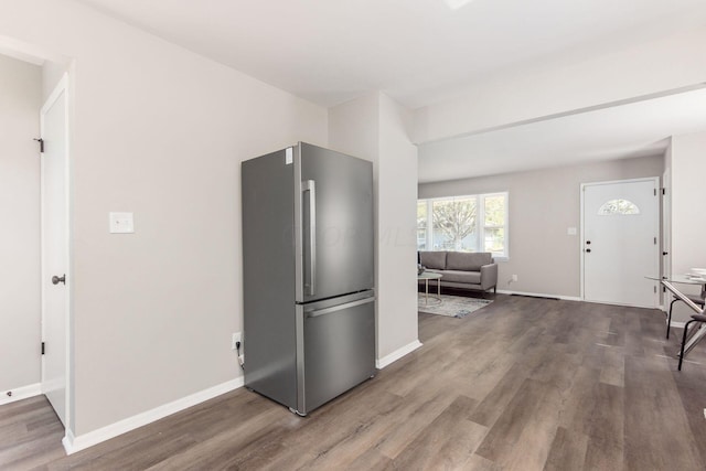 kitchen with wood-type flooring and stainless steel refrigerator