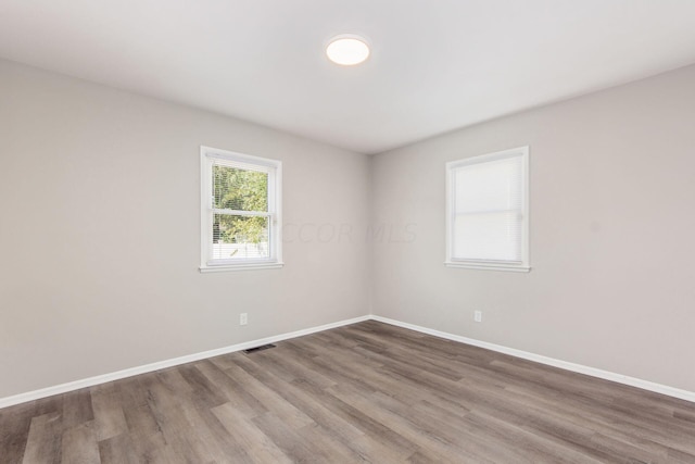 empty room with wood-type flooring