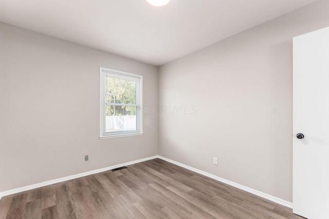 empty room featuring wood-type flooring