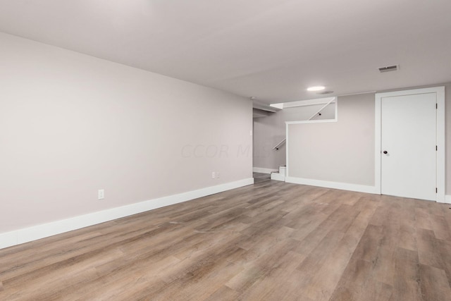 basement with hardwood / wood-style flooring