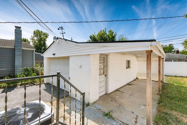 view of outdoor structure featuring cooling unit and a garage