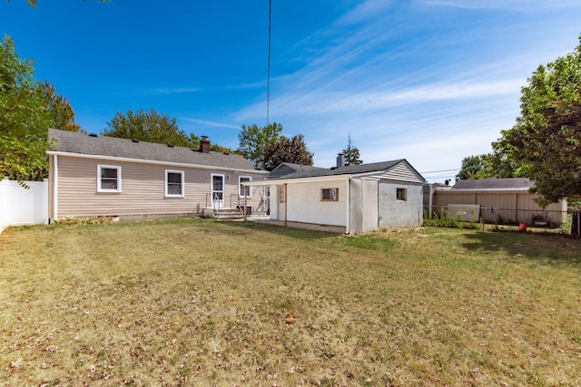 back of house with a yard