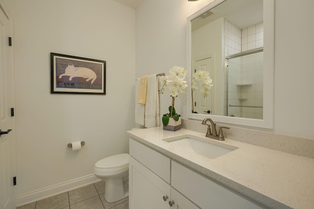 bathroom with tile patterned flooring, vanity, toilet, and walk in shower