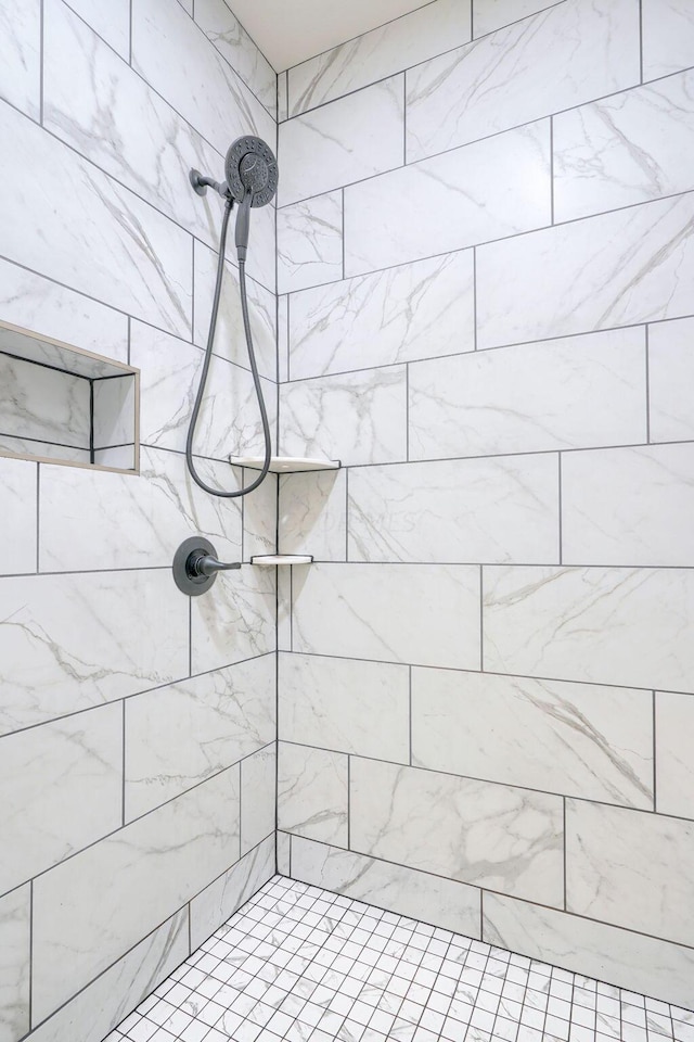 bathroom with a tile shower