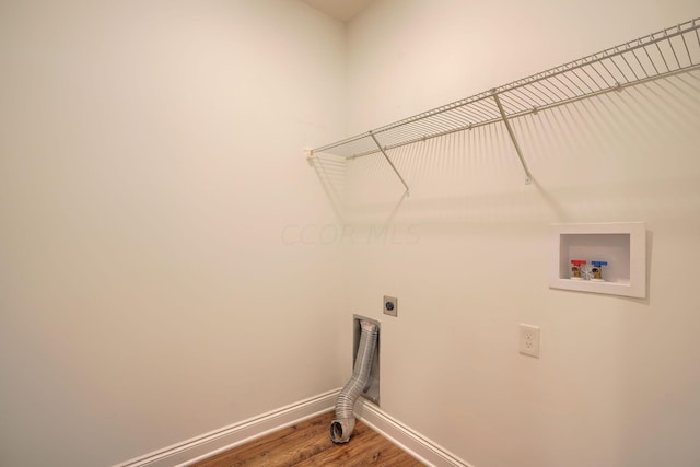 laundry area with hardwood / wood-style flooring, electric dryer hookup, and washer hookup