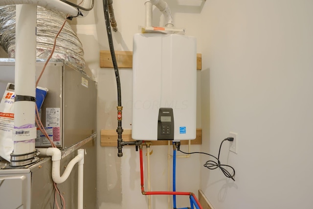 utility room featuring heating unit and tankless water heater