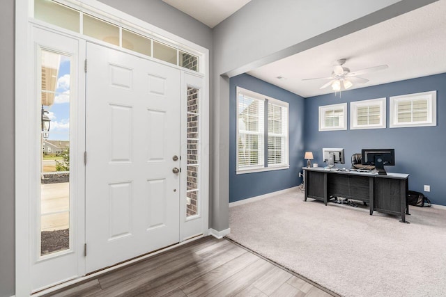 foyer with ceiling fan and hardwood / wood-style flooring