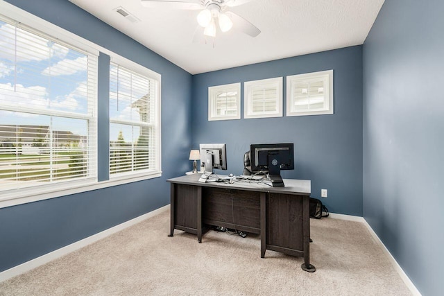 carpeted office featuring ceiling fan