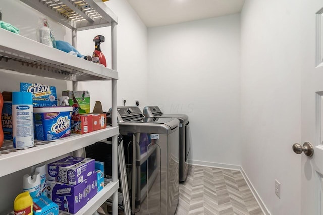 washroom featuring separate washer and dryer and parquet flooring