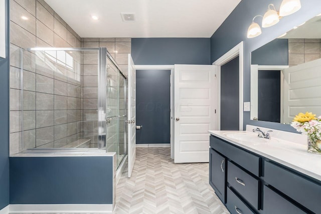 bathroom with vanity, an enclosed shower, and parquet flooring