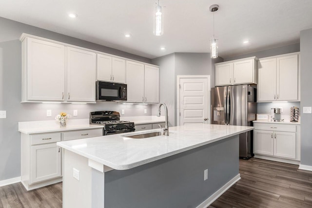 kitchen featuring white cabinetry, pendant lighting, black appliances, and dark hardwood / wood-style floors