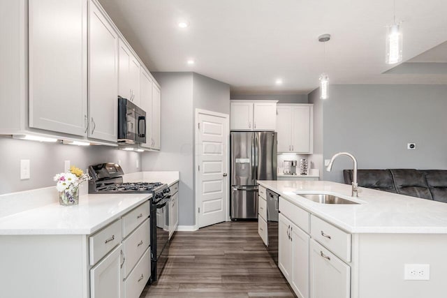 kitchen with pendant lighting, black appliances, sink, dark hardwood / wood-style floors, and white cabinetry