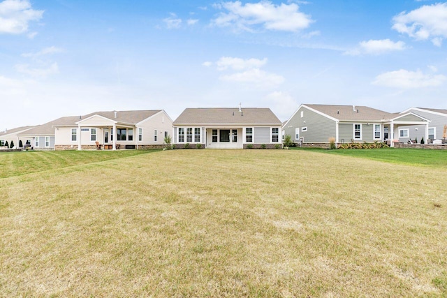 rear view of property with a yard