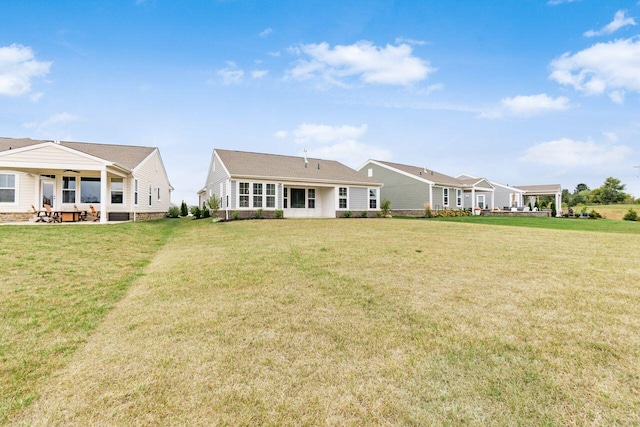 back of house featuring a yard