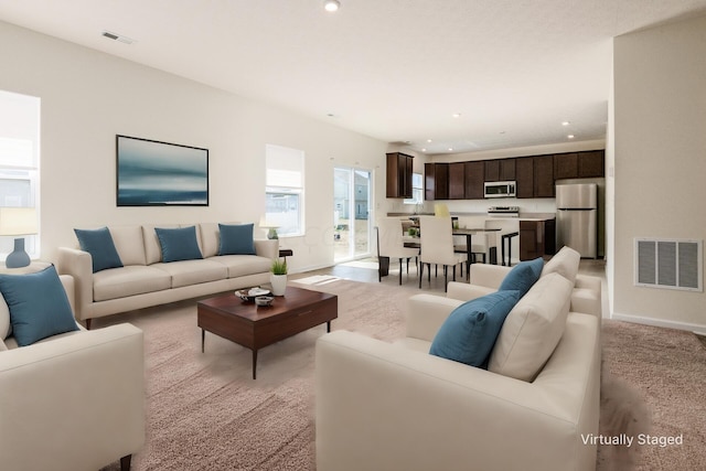 living room featuring light colored carpet and sink