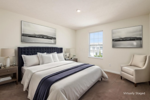 bedroom with dark colored carpet