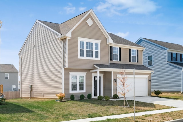 view of front of property featuring a front yard and a garage