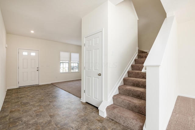 foyer entrance featuring carpet floors