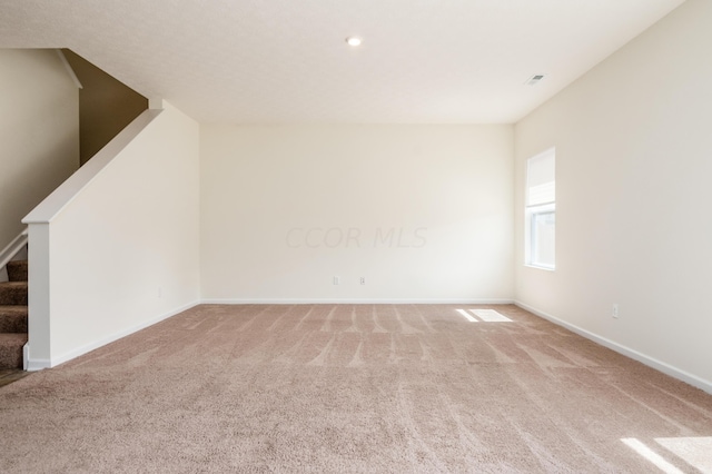 unfurnished room featuring light colored carpet