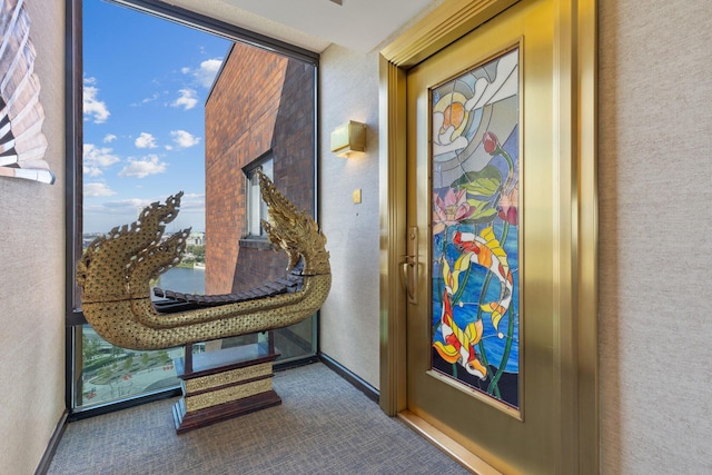 interior space with floor to ceiling windows, carpet flooring, and a healthy amount of sunlight