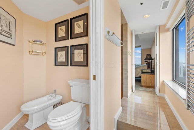 bathroom featuring a bidet and toilet