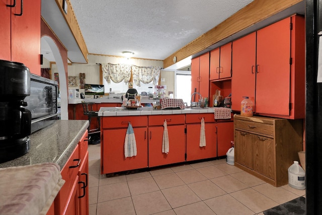 kitchen with light tile patterned floors and a textured ceiling