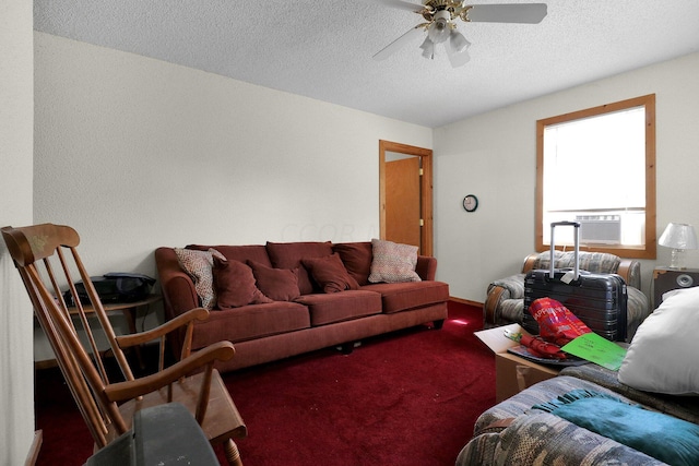 living room featuring ceiling fan, carpet floors, and a textured ceiling