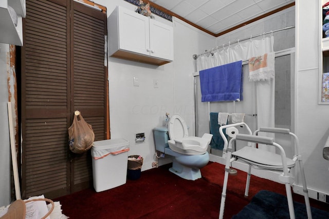 bathroom with toilet, ornamental molding, and walk in shower