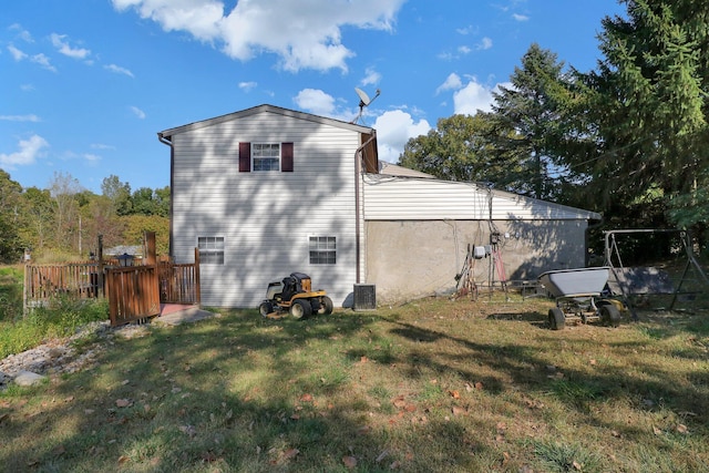 view of side of property featuring a yard and central air condition unit