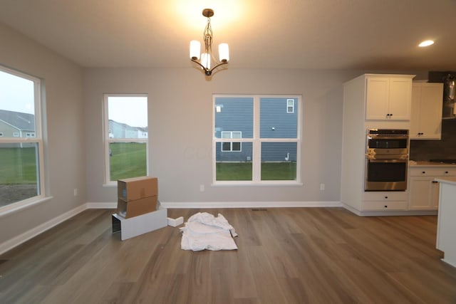 dining room featuring light wood-type flooring and an inviting chandelier