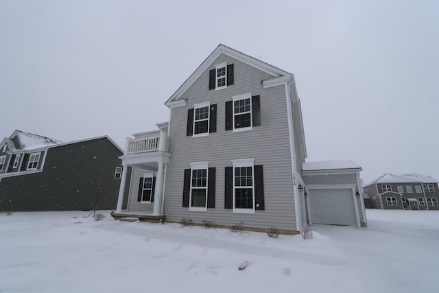 view of front of home featuring a balcony and a garage