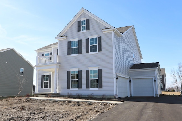 view of front of home with a garage and a balcony