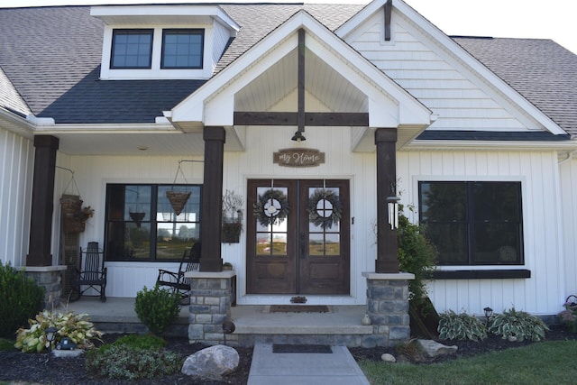 entrance to property with a porch and french doors