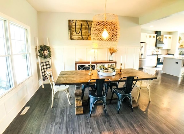 dining space with dark hardwood / wood-style flooring