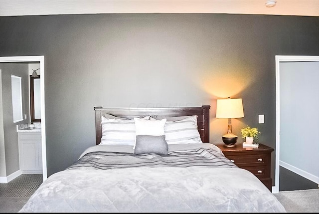 carpeted bedroom featuring ensuite bathroom