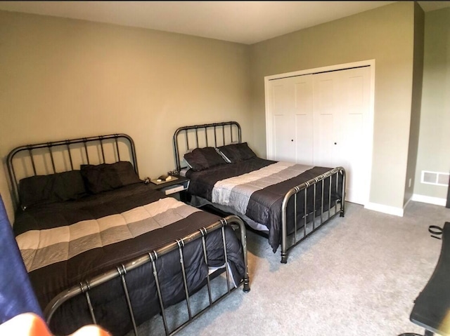 carpeted bedroom featuring a closet