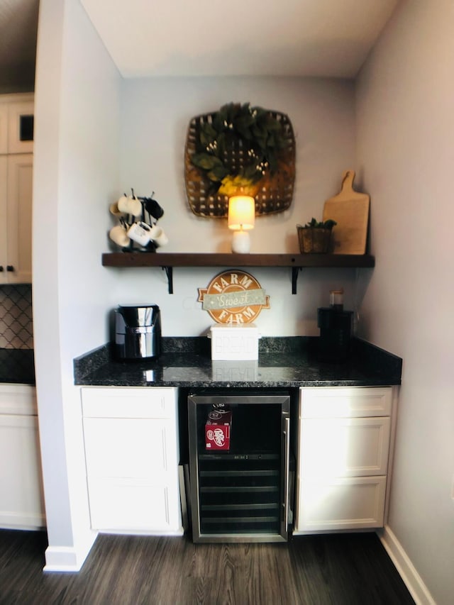 bar with backsplash, wine cooler, white cabinets, and dark wood-type flooring