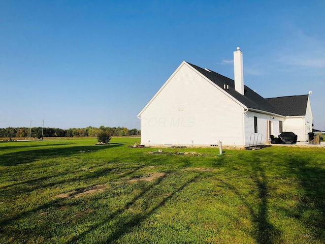 view of property exterior featuring a garage and a lawn