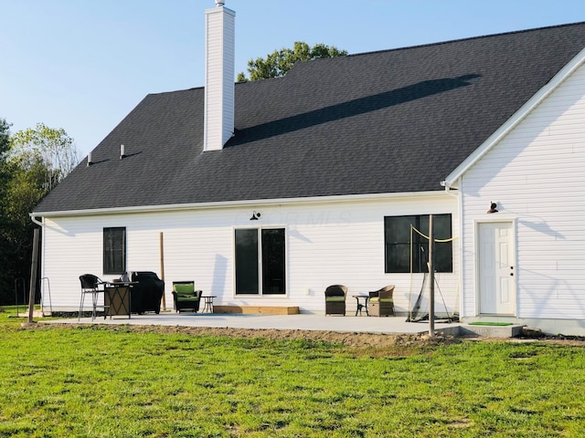 back of house featuring a patio and a lawn